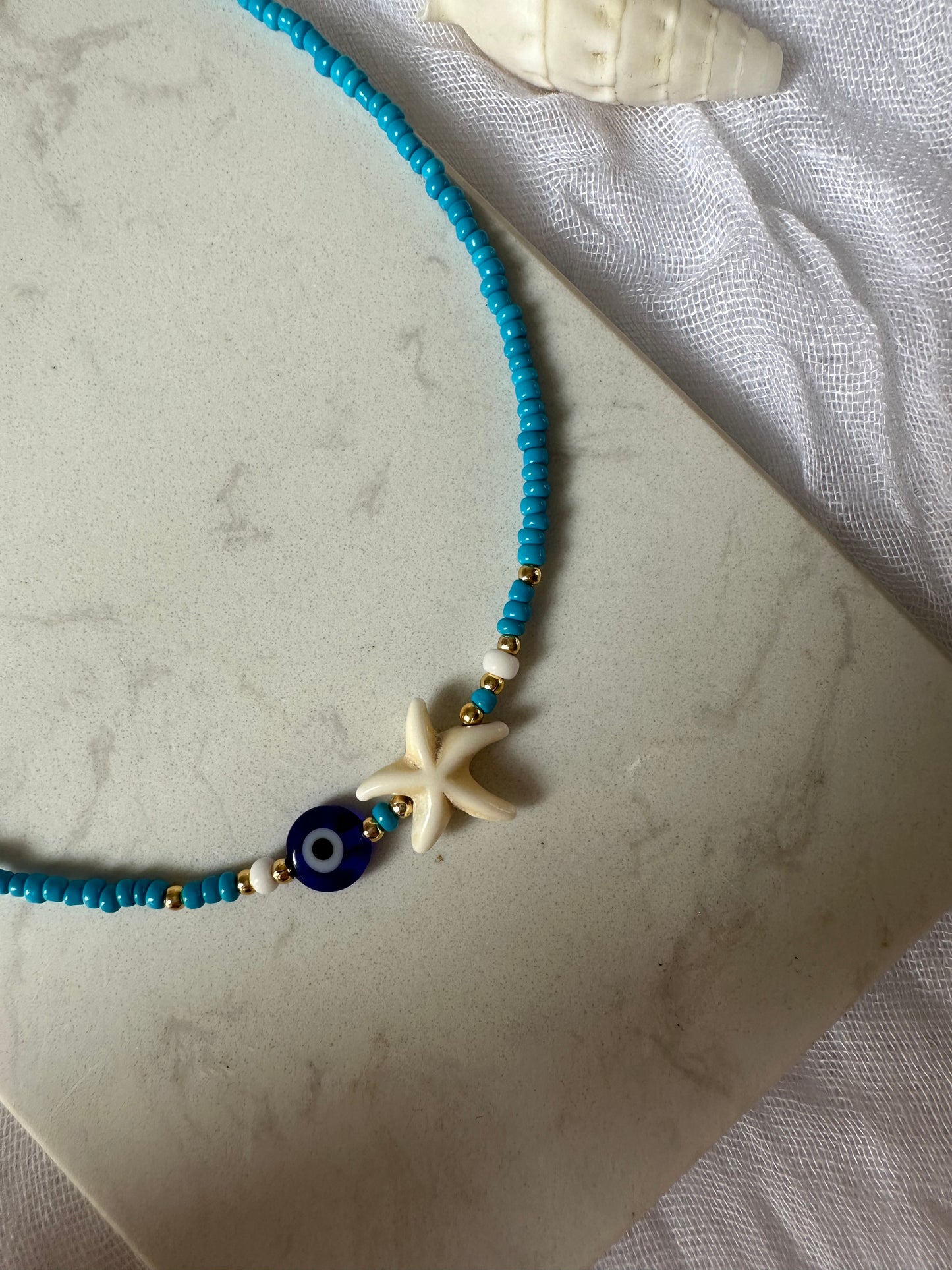 Perlenkette mit Blauen Perlen und Nazar + Seestern Anhänger - 10128