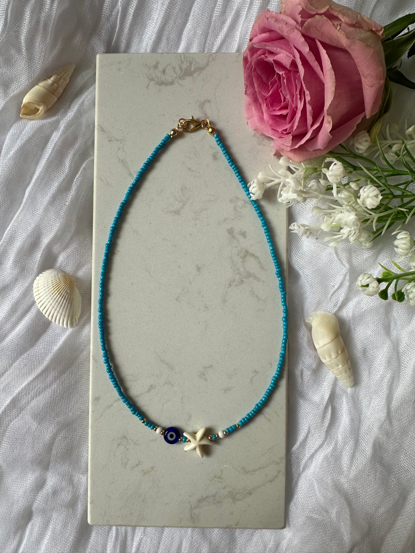 Perlenkette mit Blauen Perlen und Nazar + Seestern Anhänger - 10128