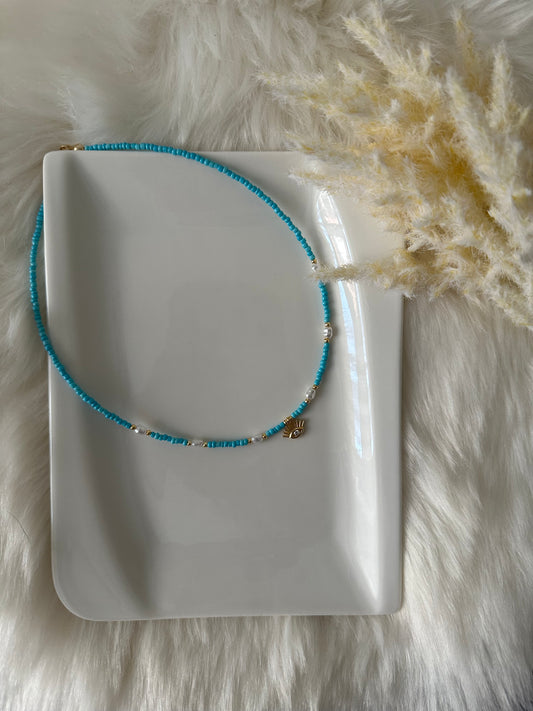 Perlenkette chocker blau mit kleinen Süßwasserperlen und Augen Anhänger - 10179